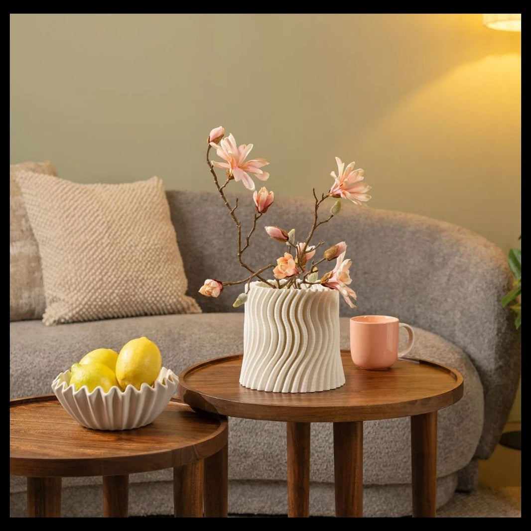 Living room with a gray sofa, wooden coffee table, and decorative items.