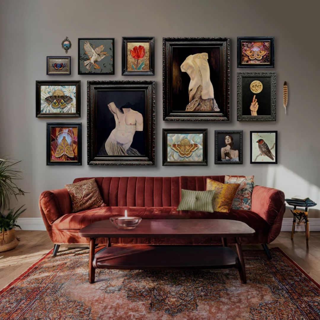 Living room with a red sofa and wall displaying various framed artworks.