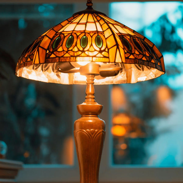 Tiffany-style lamp with stained glass shade on a blurred background