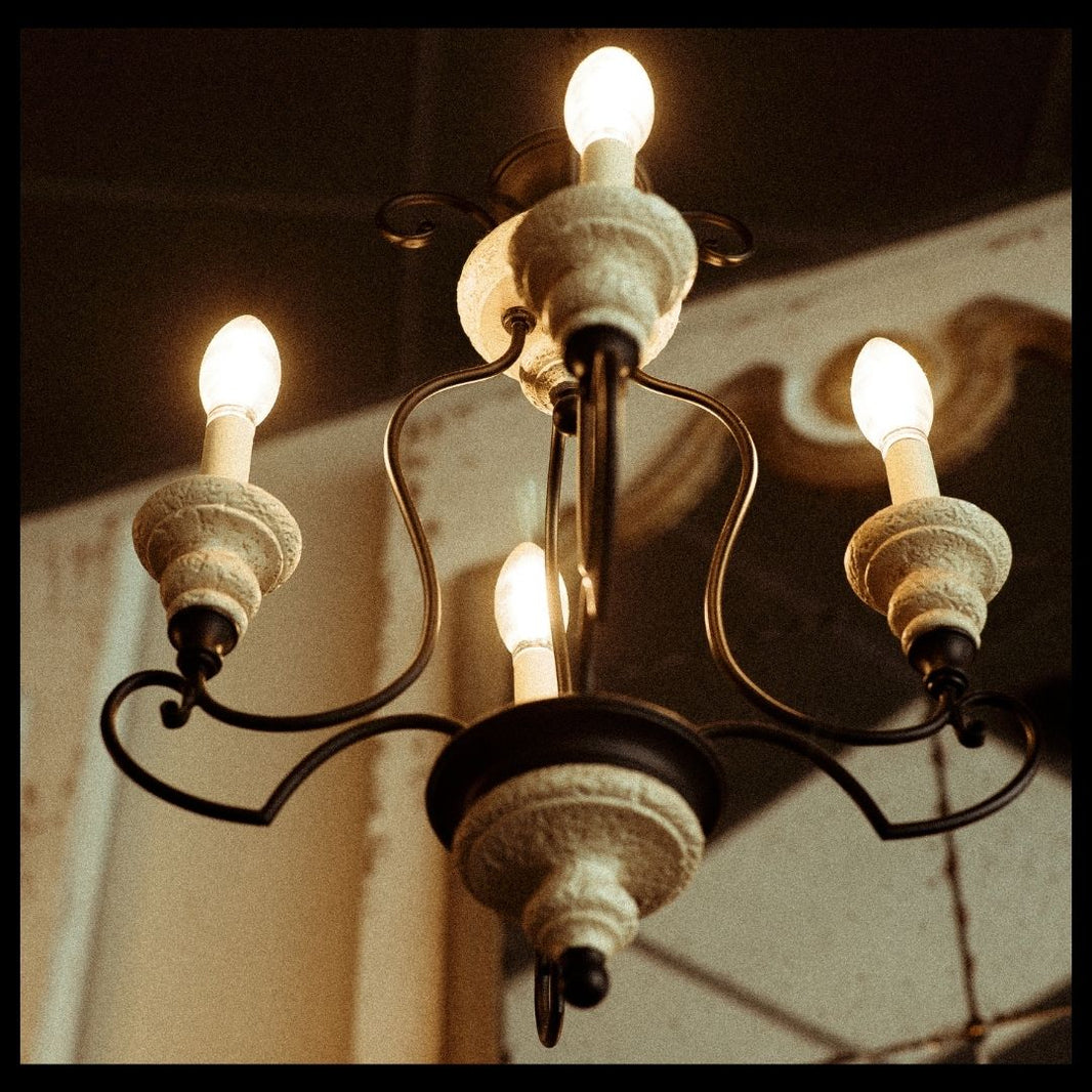 Vintage-style chandelier with five light bulbs on a dark background