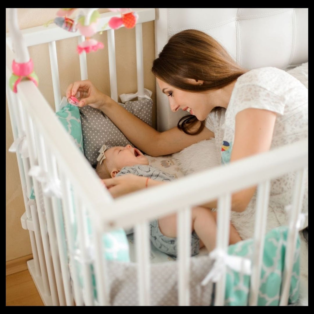 Woman interacting with a baby in a crib